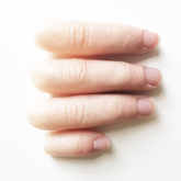 Close up of four silicone digits lined up next to each other with a white skin tone