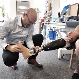 Socket Designs Prosthetist checking alignment and fit of an above right knee amputee patient's socket and prosthetic device