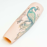 Silicone prosthesis forearm cover with coloured peacock tattoo and a white skin tone