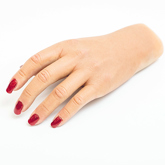 Close up of Silicone hand prosthesis with red nail varnish with a white skin tone