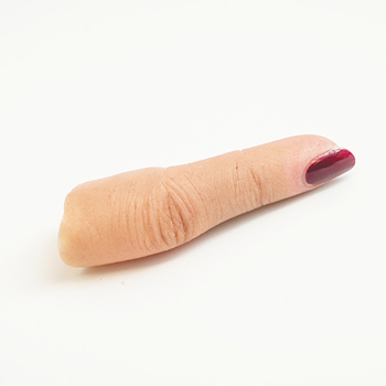 Close up of realistic silicone finger with red nail varnish
